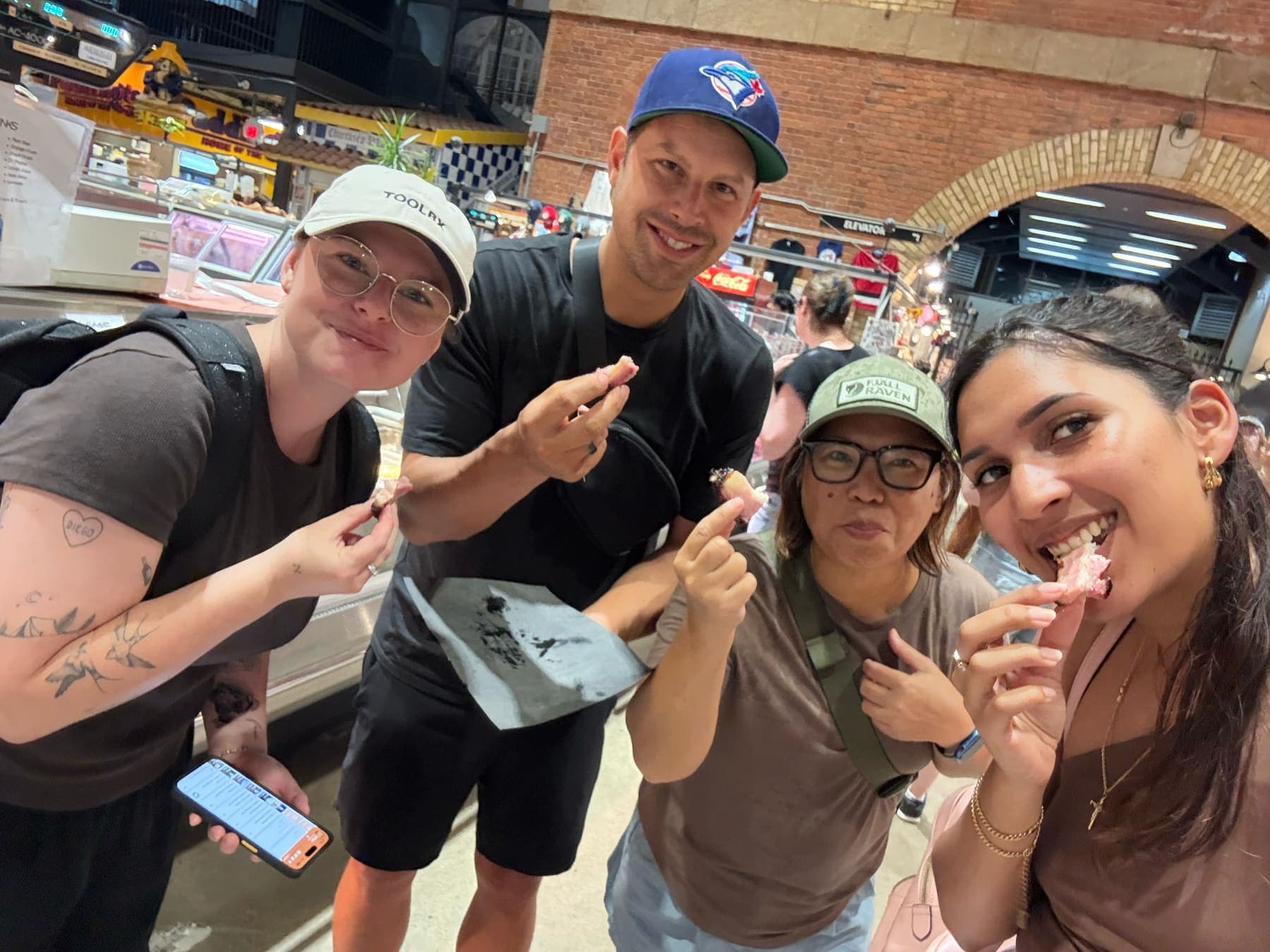 Teammates sharing food at St Lawrence Market in Toronto