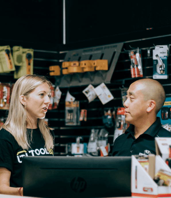A Toolbx team member talking with a dealer behind the counter