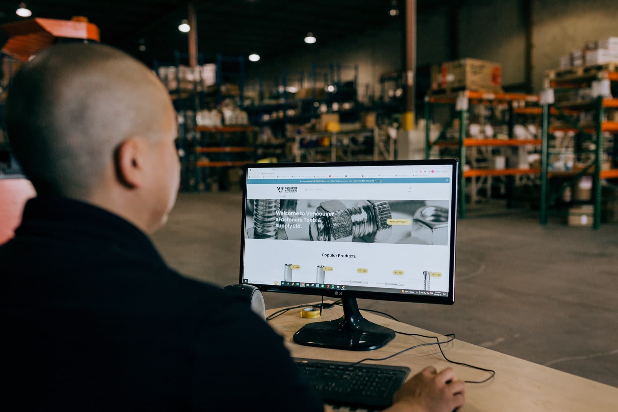 A Pro at a warehouse desk ordering from a Toolbx dealer's online storefront